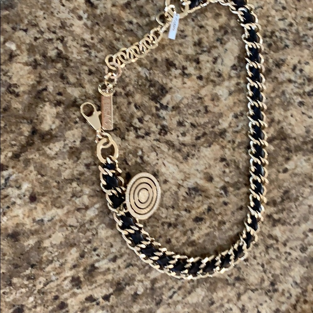 Versace gold chain and black leather belt.